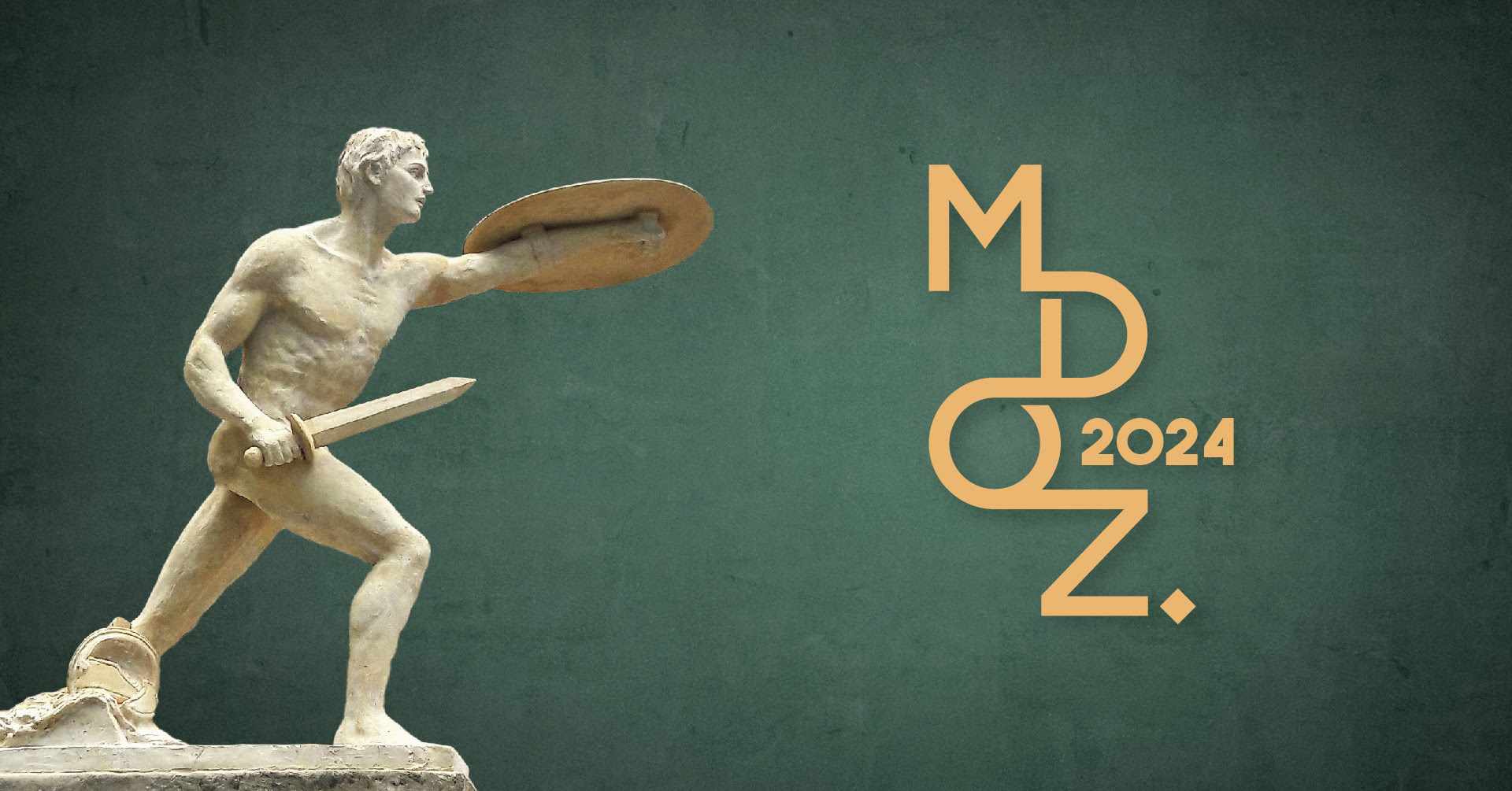 rzeźba przedstawiająca nagiego wojownika trzymającego w prawym ręku miecz a w lewym tarczę oraz napis MDOZ 2024 na zielony tle